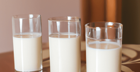 3 glasses of milk on the kitchen table